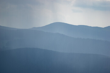 Carpathian mountains and forests in the haze on a summer day