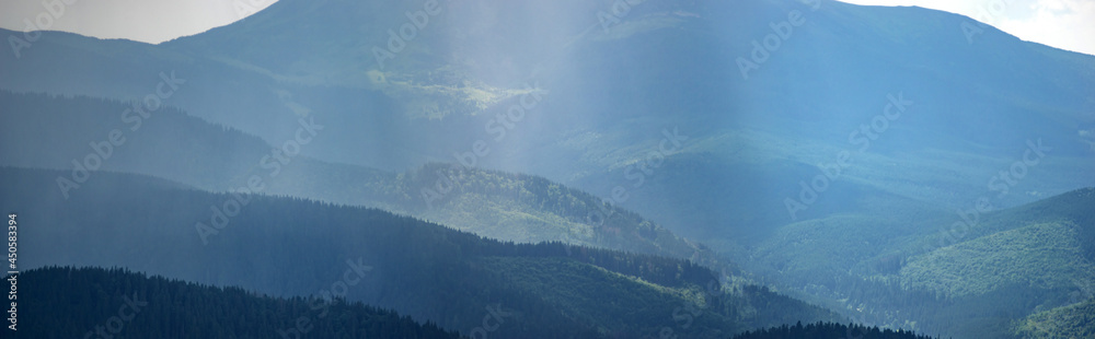 Wall mural sun rays and rain in the carpathian mountains in summer