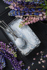 Ice cream in vintage can.  Fresh frozen dessert. Summer joy. Violet syrup, blueberry lavender flavor. Metal tray selective focus. 