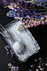 Ice cream in vintage can.  Fresh frozen dessert. Summer joy. Violet syrup, blueberry lavender flavor. Metal tray selective focus. 