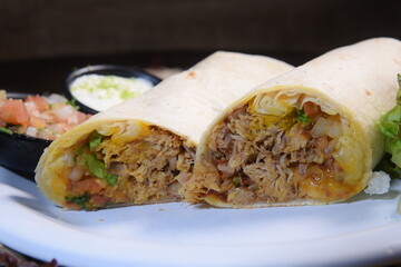Burritos wraps with beef and vegetables on black background. Beef burrito, mexican food. Banner