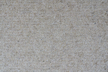Sheet of recycled cardboard brown textured background. Close-up detail view of abstract texture recycled eco-friendly material pattern background.