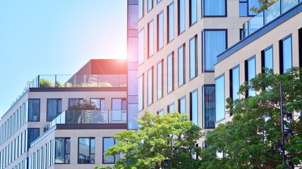 Modern glass office building with green leaves. Eco building  and greens  plants  in city concept.