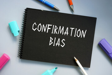 Business concept about Confirmation Bias with sign on the piece of paper.