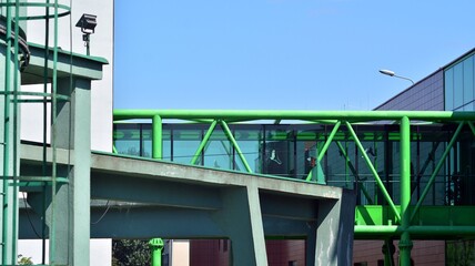 View of office building with glass wall under blue sky. Architecture details of business background.