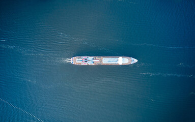 Top down view of the ship is floating on water aerial view from above