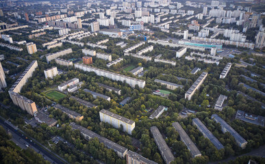 Aerial view of the old residential buildings in the city and green tree areas between houses