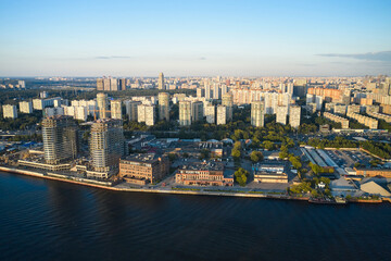 Aerial of construction site on a coastline of the river in big city