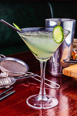 Cucumber martini cocktail on wooden table