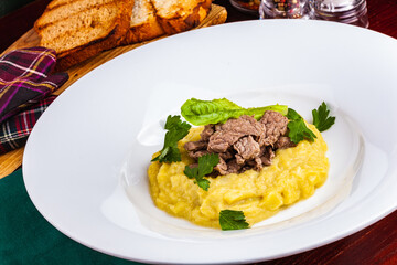 Beef Stroganoff with mashed potatoes on white plate