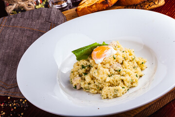 Couscous with chicken and egg on a white plate