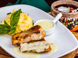 Fried fish with mashed potatoes on white plate