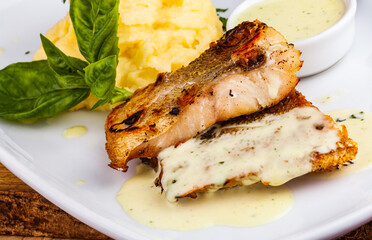 Fried fish with mashed potatoes on white plate