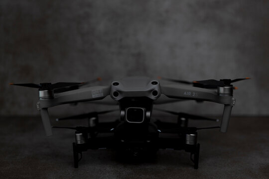 Zutphen, The Netherlands - August 6, 2021: Low key dark moody studio still life of new DJI Air 2S drone with modern metal gray pattern stylish background.