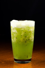 Fresh kiwi cocktail with mint on dark blue background. Summer cold drink and cocktail