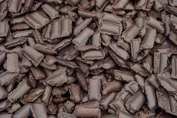 Hot briquetted iron close-up. Lumps of ore concentrate. Semi-finished product of the metallurgical production of iron. - obrazy, fototapety, plakaty