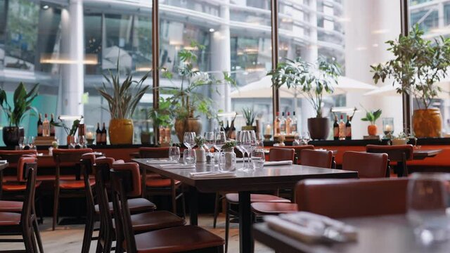 Panning shot of restaurant interior with set tables
