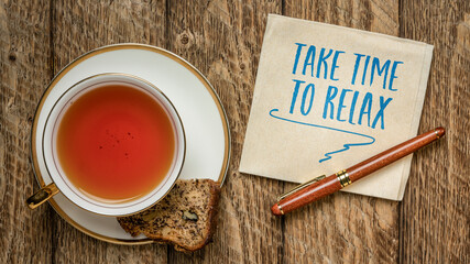 take time to relax, inspirational reminder - handwriting on a napkin with a cup of tea and banana...