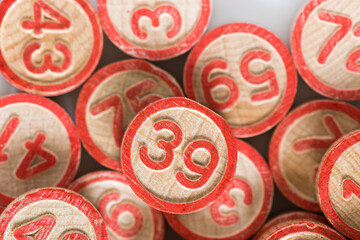 retro bingo game pieces or solid wood discs with numbers up close