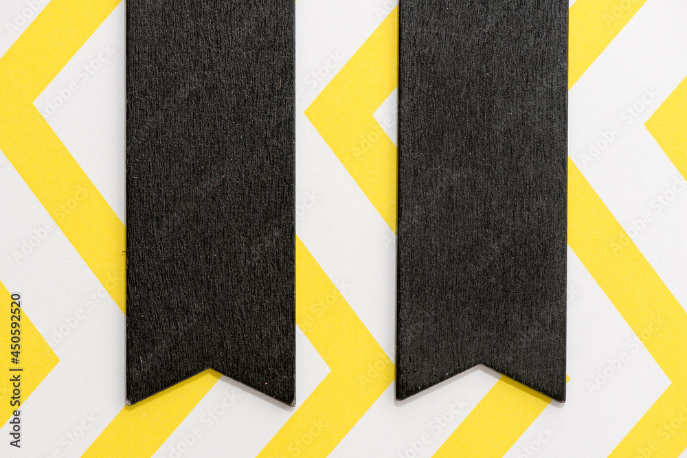 Wall mural two black chalk banner tags on chevron patterned yellow and white paper background