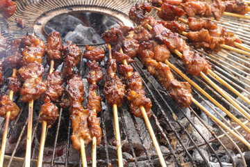 The process of burning savory beef satay with spicy spices over hot coals.hot and spacy satay