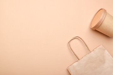 Paper packaging on a beige background. Food delivery, takeaway food. Environmental protection. Zero waste.