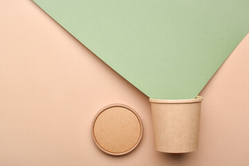 Paper packaging on a beige background. Food delivery, takeaway food. Environmental protection. Zero...