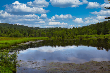 Fototapeta na wymiar A cloudy sky above Crystal lake in the Catskill mountain region in upstate, New York