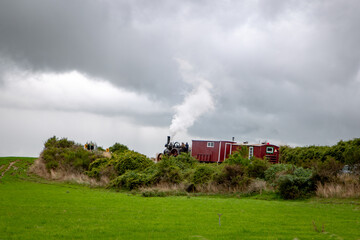 A traction engine towing cabins works its way up the Waimakariri Gorge Road heading towards...