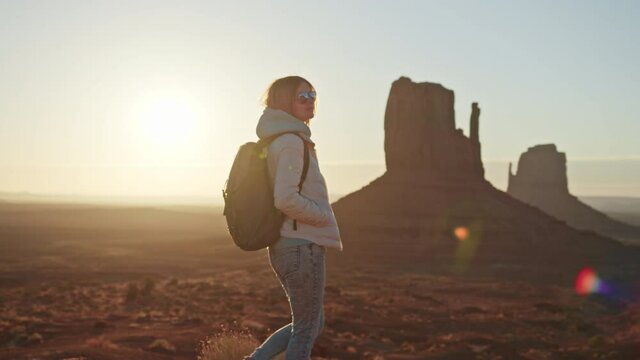 4K slow motion footage woman hiking red canyon cliffs on scenic sunrise, Travel