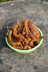 close up dry tamarind on plastic basket