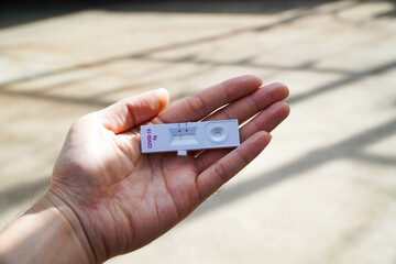 Positive test result by using rapid test for COVID-19, quick fast antibody point of care testing.Self-test for COVID at home