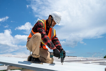 Roofing,Construction workers wearing safety harness checking and installation assembly of new...