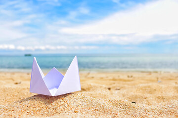 Fototapeta na wymiar Paper boat on the beach