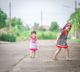 close-up background view of an asian girl Running around and carrying parasols during school holidays, there was a blur of fun movements during the day with parents.