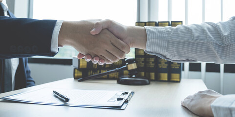 Handshake after Lawyer  providing legal consult business dispute service to the man at the office with justice scale and gavel hammer