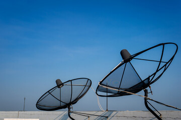 Satellite dish on deck of building and blue sky with coppy space