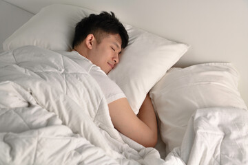 Handsome Young Asian man sleeping in bed