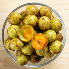 Cloase up ceylon oak , Schleichera oleosa in glass cup top view.