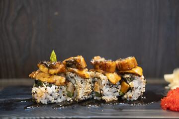 Sushi roll white and black sesame seeds and eel on top