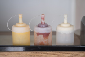 Different sauces in plastic bottles