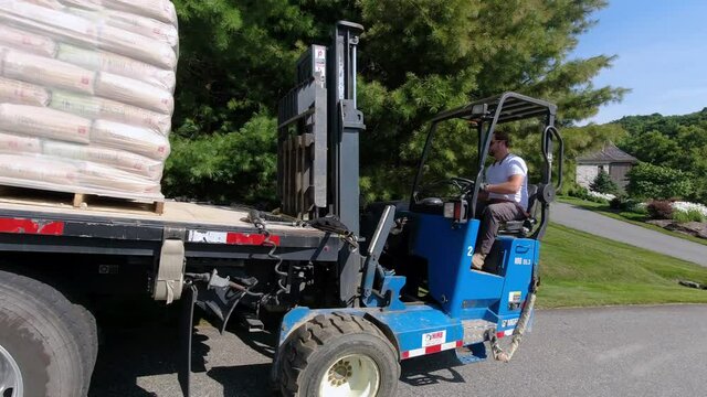 Forklift offfloaded from construction truck