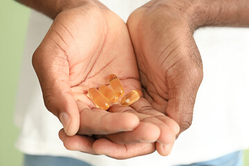 African-American man with fish oil, closeup