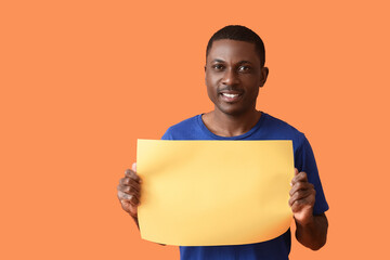 African-American man with blank poster on color background