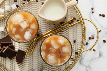 Composition with glasses of tasty iced coffee on light background