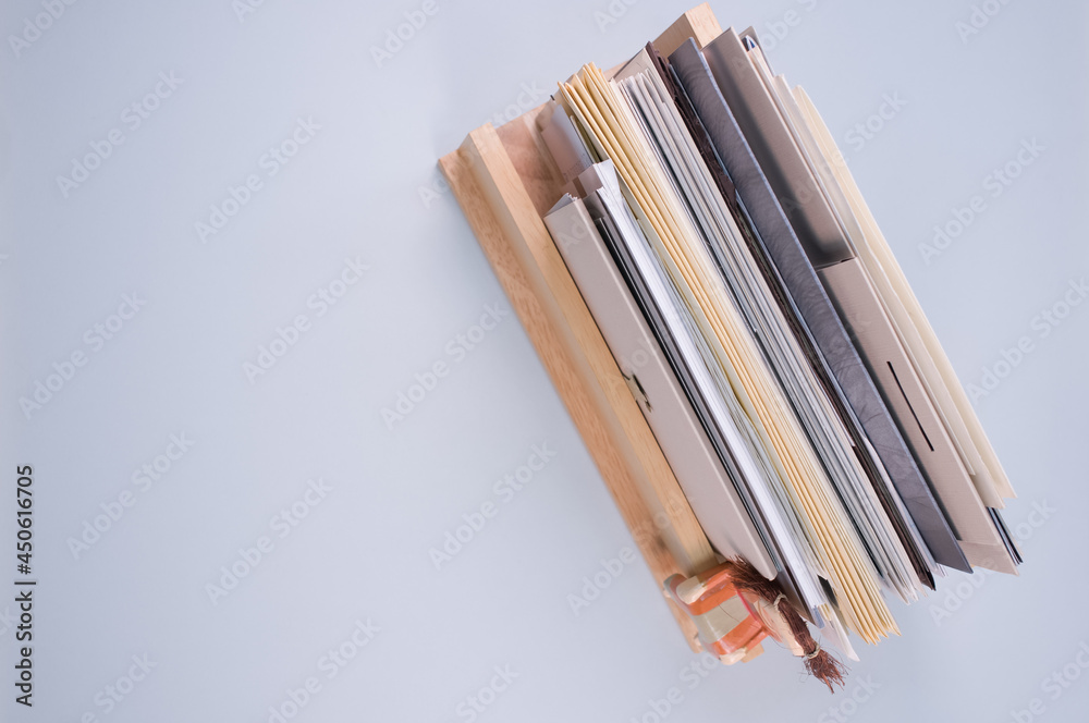 Sticker top view of filled documents on a wooden shelf isolated on light gray background