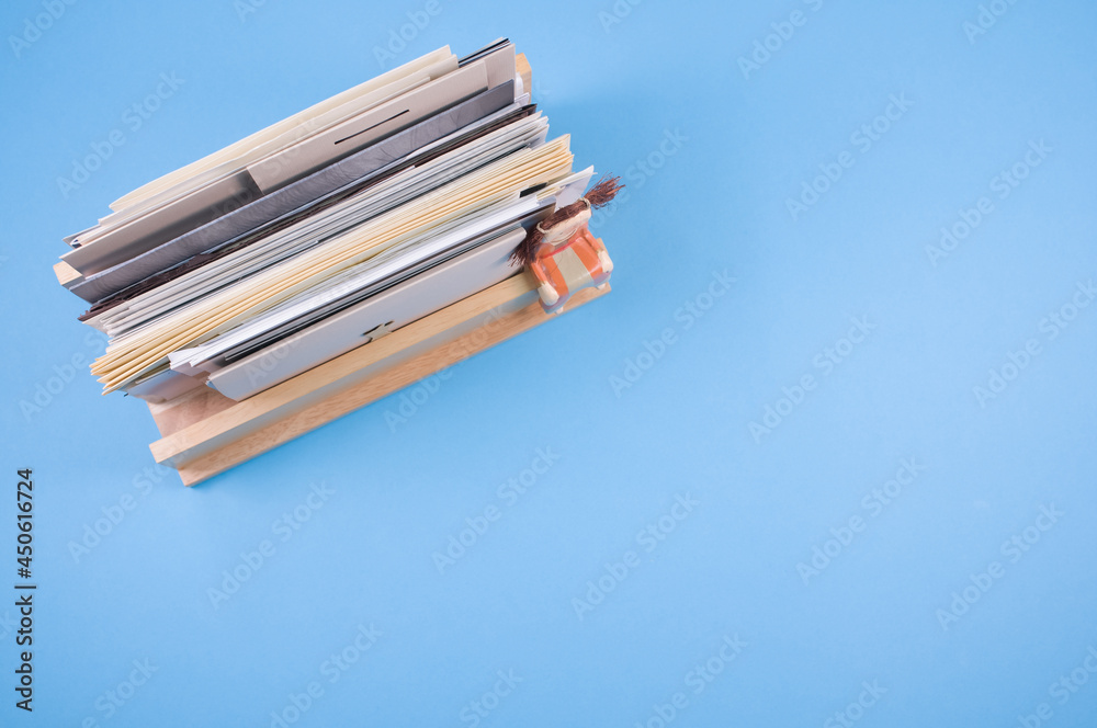 Sticker top of filled documents on a wooden shelf isolated on blue background