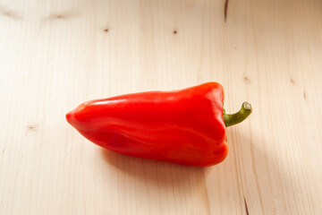 Red bell pepper on a wooden background, top view. Fresh red pepper on wooden table, space for your...