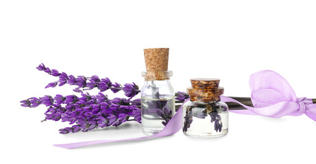 Obraz na płótnie Canvas Bottles of lavender essential oil and flowers on white background