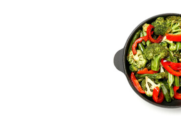 Frying pan with different vegetables on white background